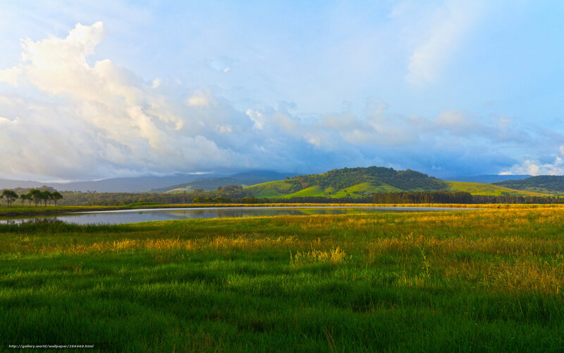 Green fields and hills at sunrise