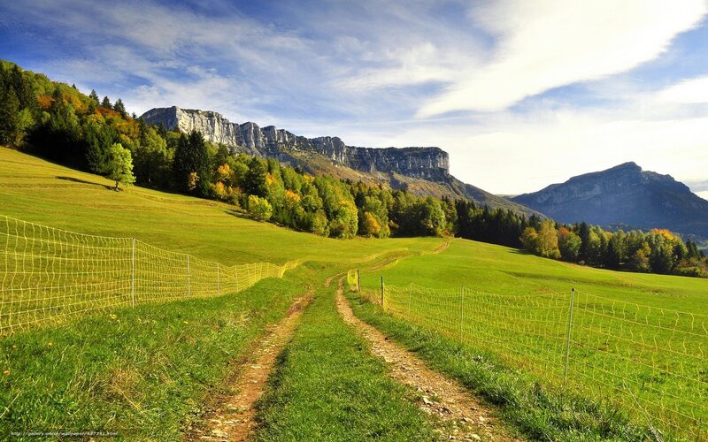 Green fields and mountain cliffs