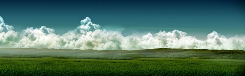 Green fields under cloudy sky