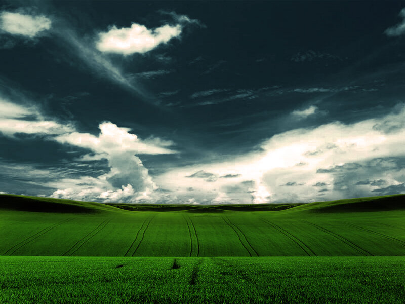 Green Fields Under Stormy Sky