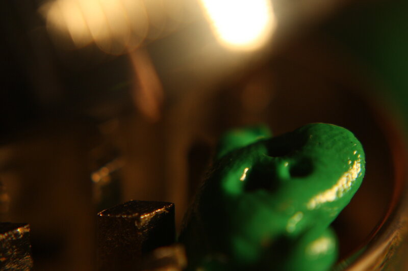 green figurine in dim light