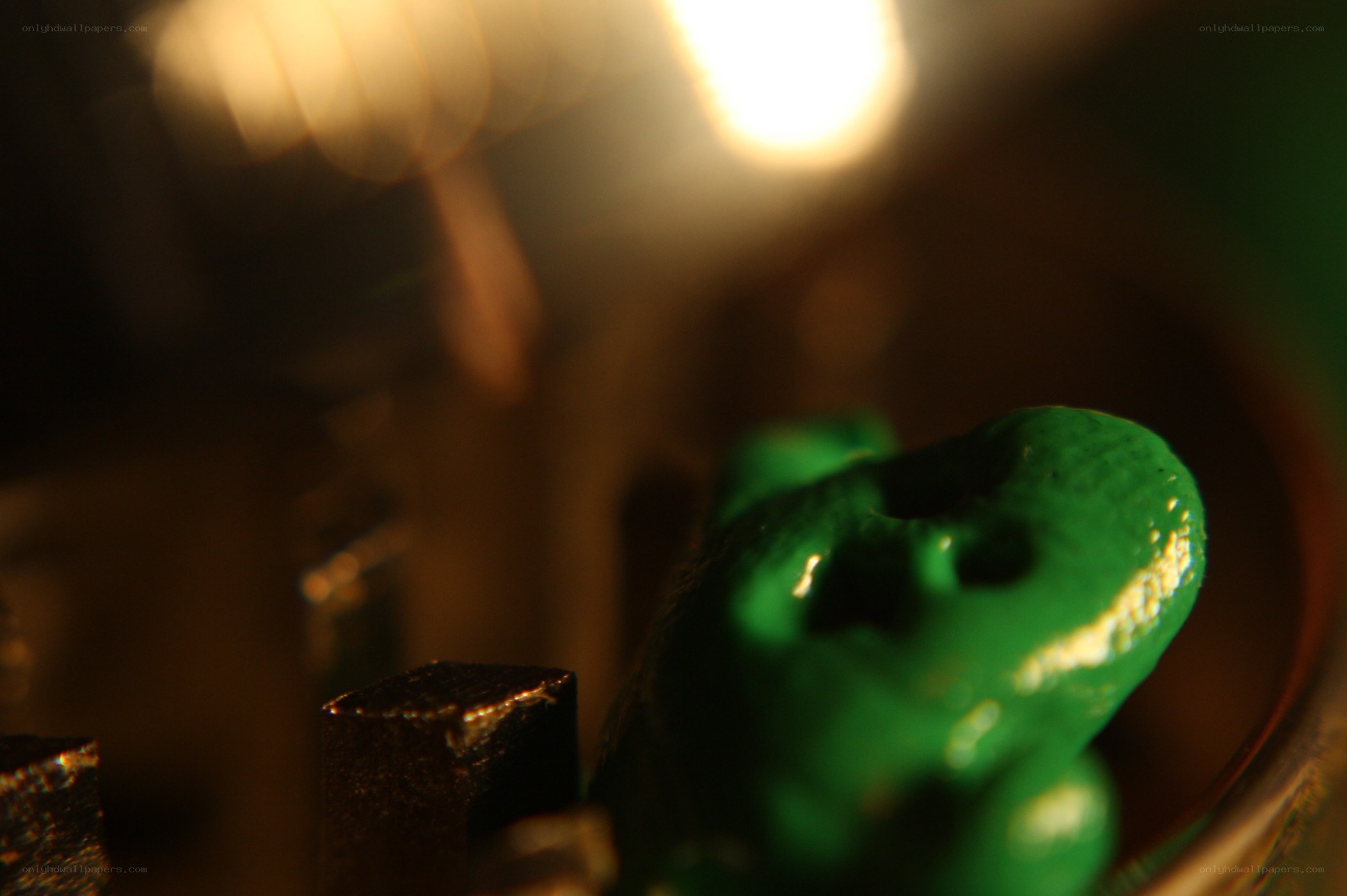 green figurine in dim light