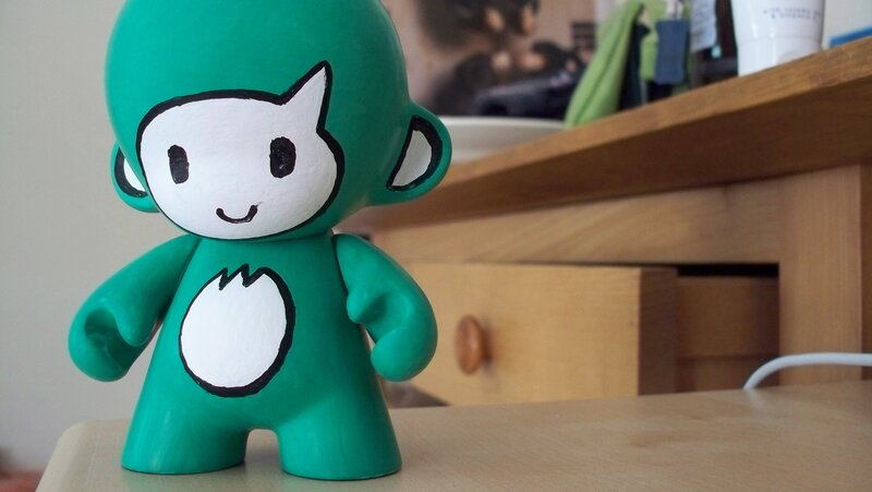 green figurine on a table