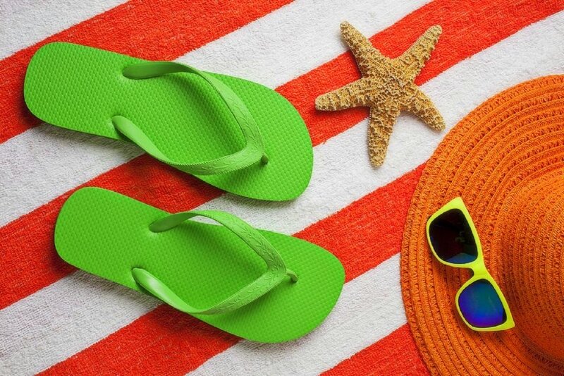 Green Flip Flops on Towel