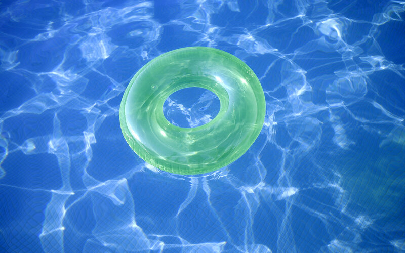 Green float in swimming pool