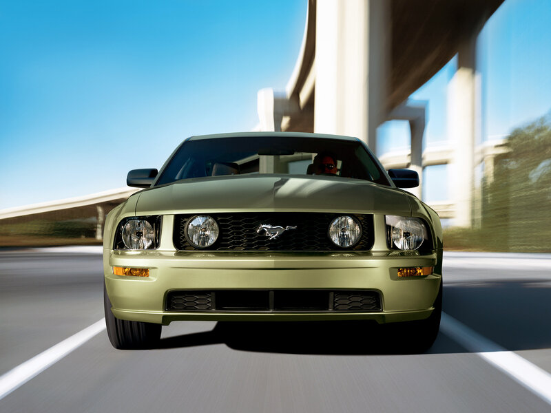 Green Ford Mustang driving on highway
