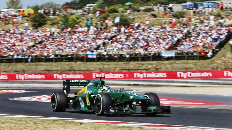 Green Formula One Car — Dynamic, Afternoon, Photograph, Crowd