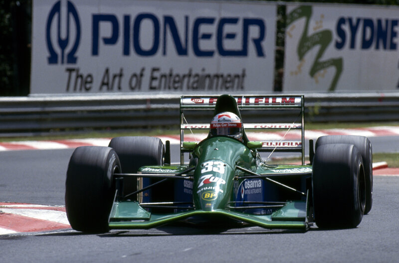 Green Formula One Car — Dynamic, Afternoon, Photograph, Driver, Race Track, Sponsor Logos
