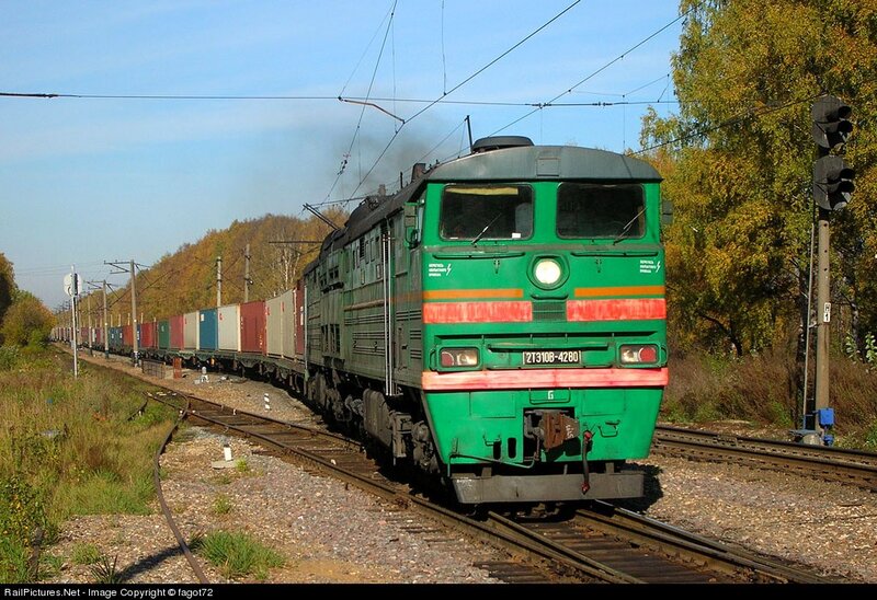Green freight train on tracks