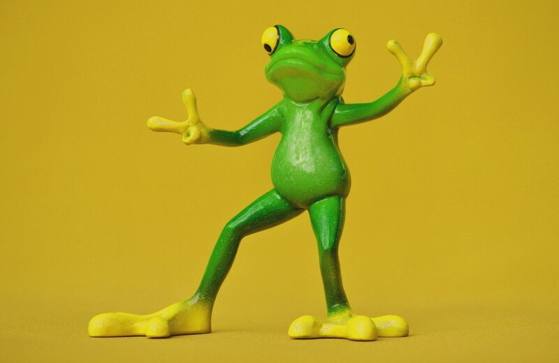 green frog figurine posing