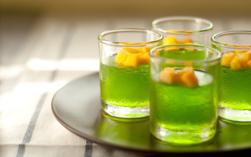 Green gelatin with fruit in glasses