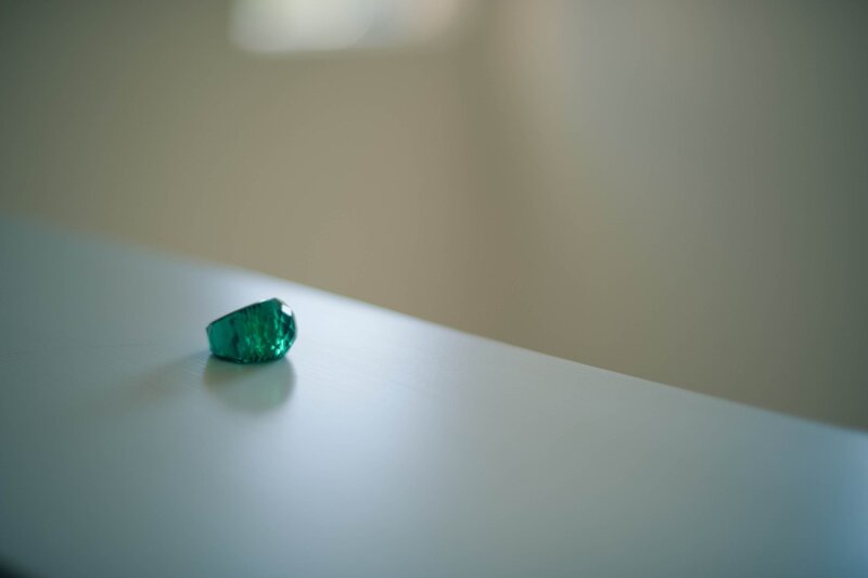 Green gemstone on a white surface