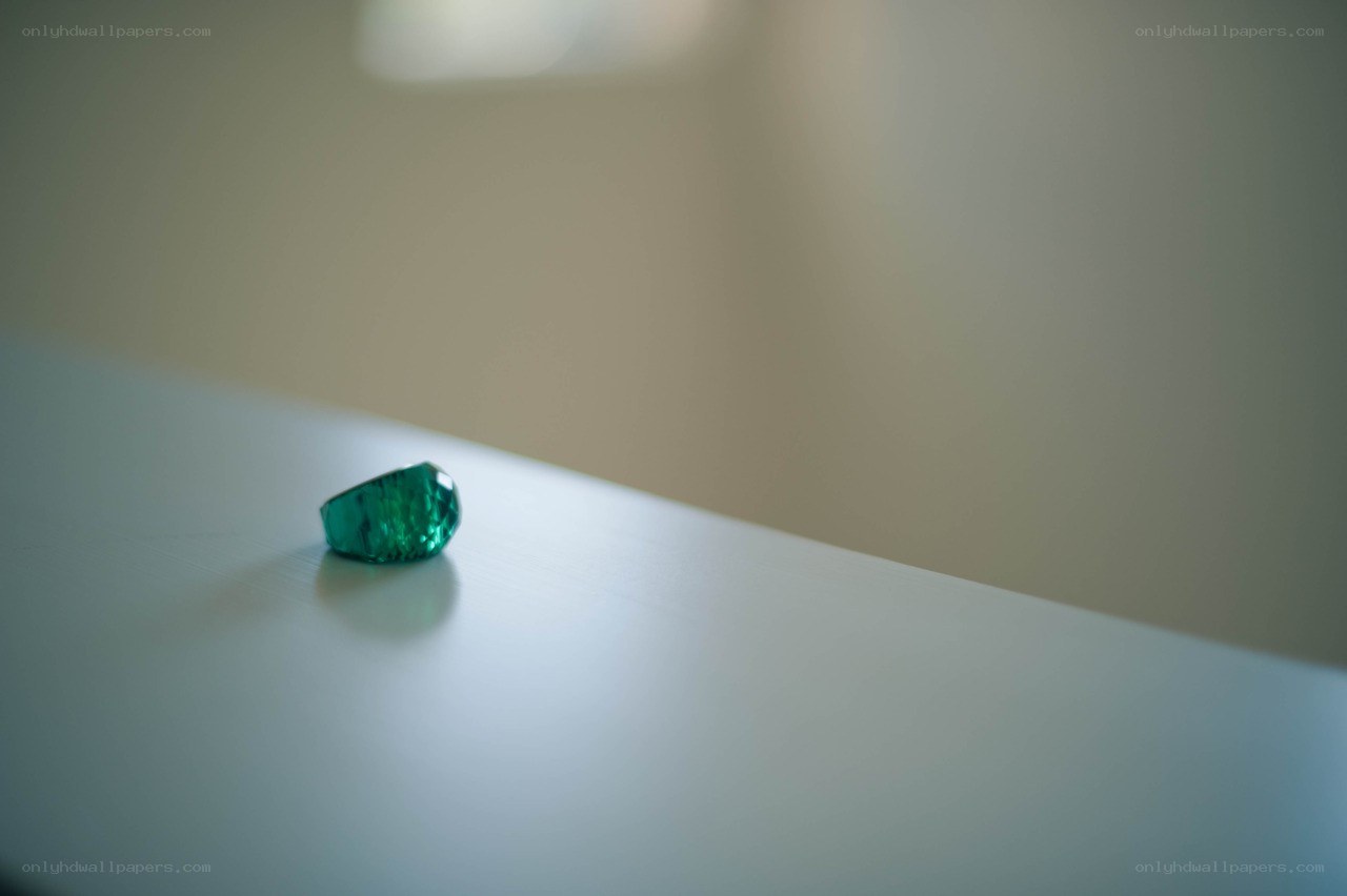 Green gemstone on a white surface