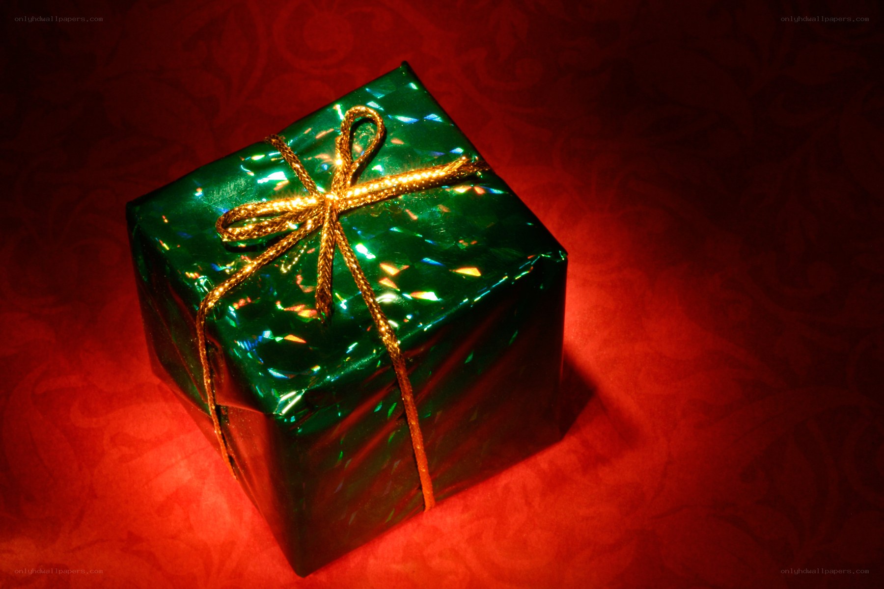green gift box with gold bow