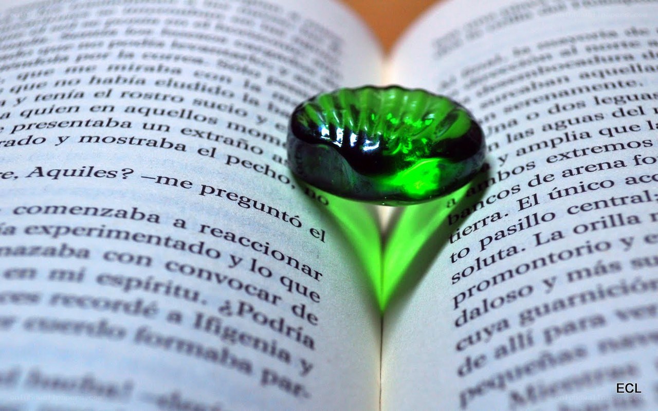 green glass heart on book