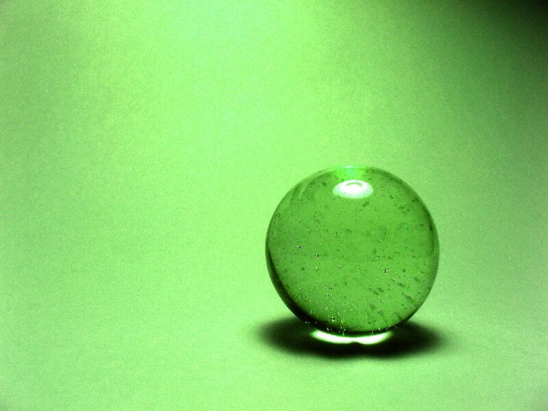green glass marble on green