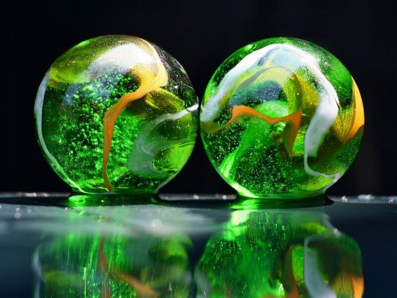Green glass marbles with swirls