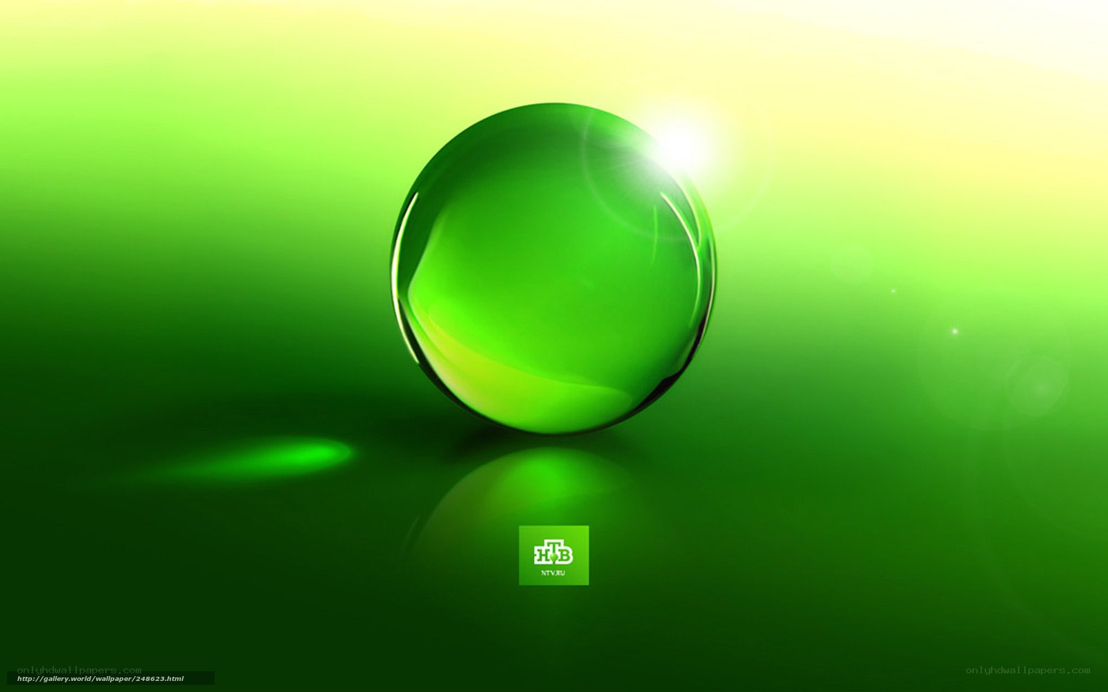 green glass sphere on reflective surface