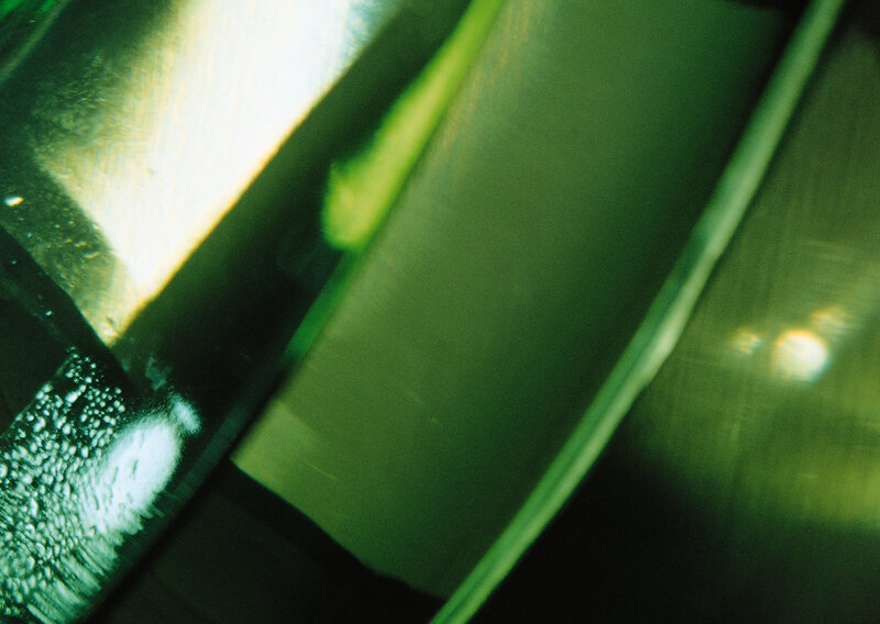 green glass surface with light reflections