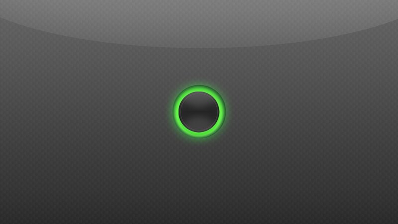 green glowing button on dark surface