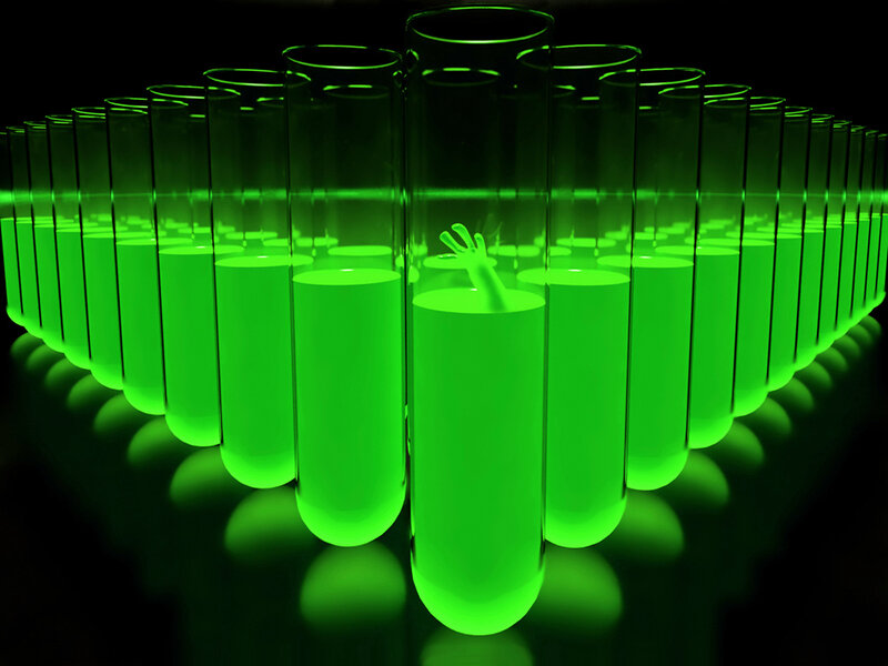 Green glowing test tubes with hand