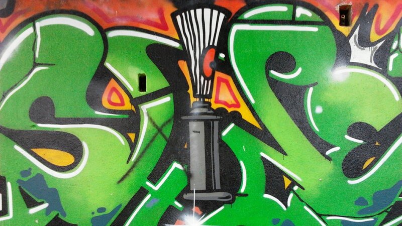 green graffiti with spray can