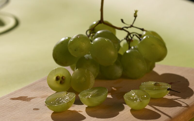 Green grapes on a cutting board