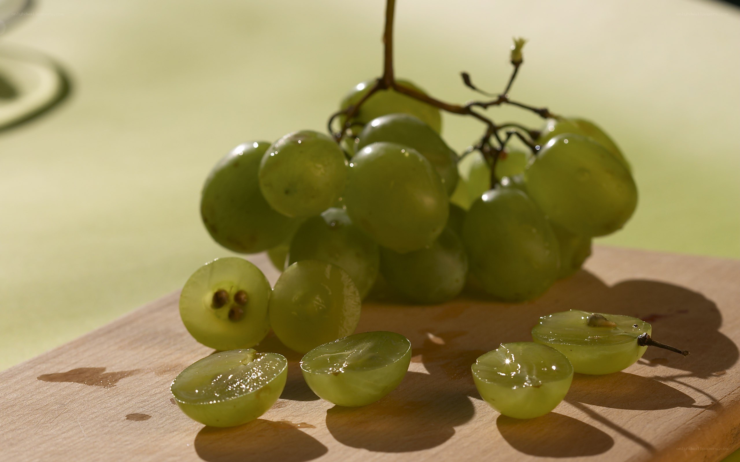 Green grapes on a cutting board