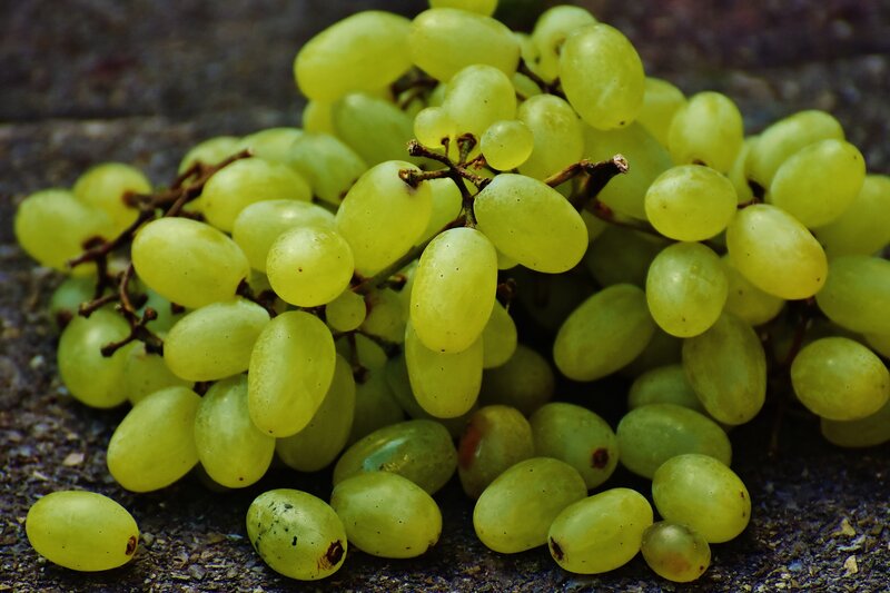green grapes on stone surface