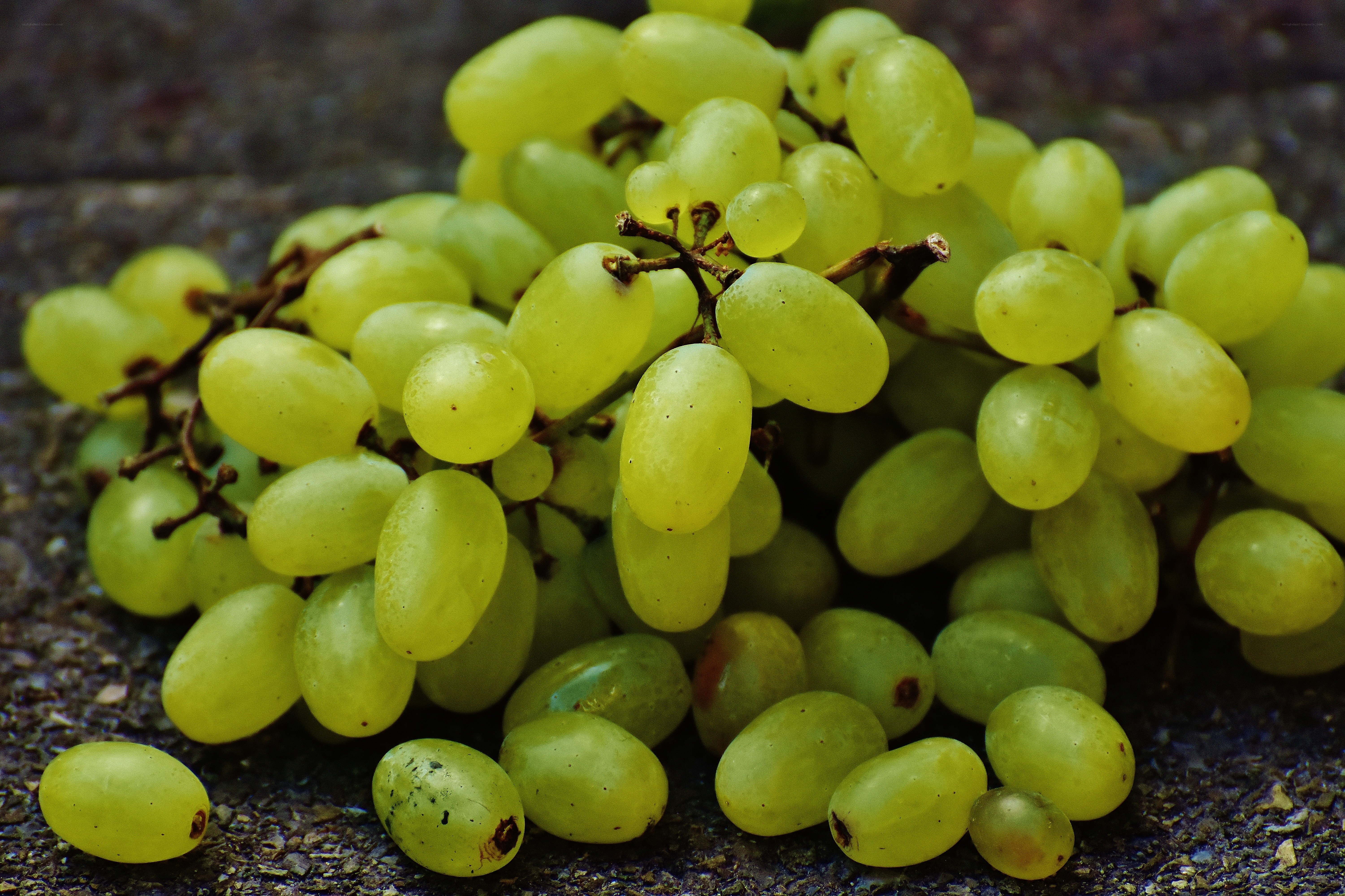 green grapes on stone surface