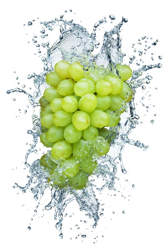 green grapes splashing in water