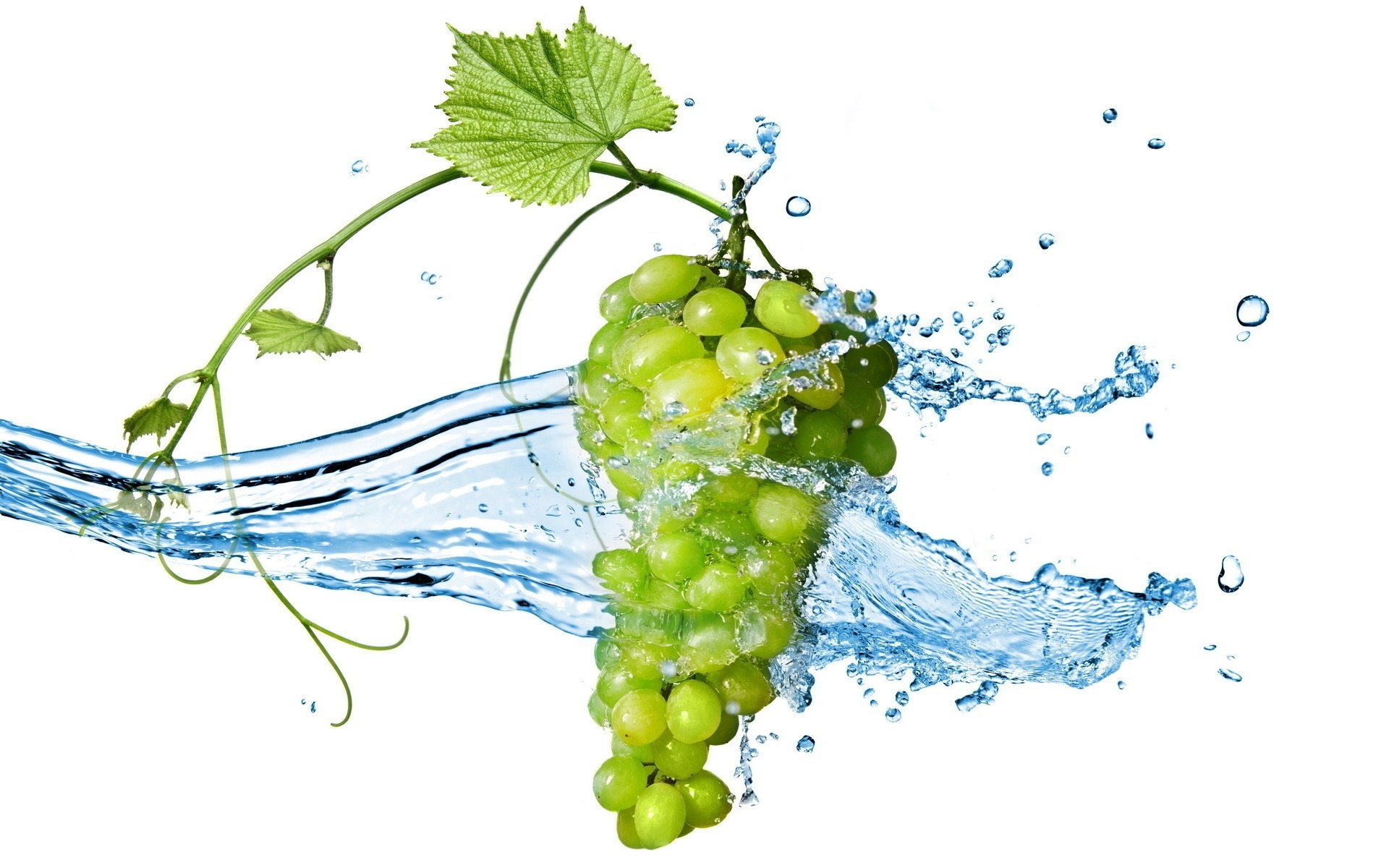 green grapes splashing in water