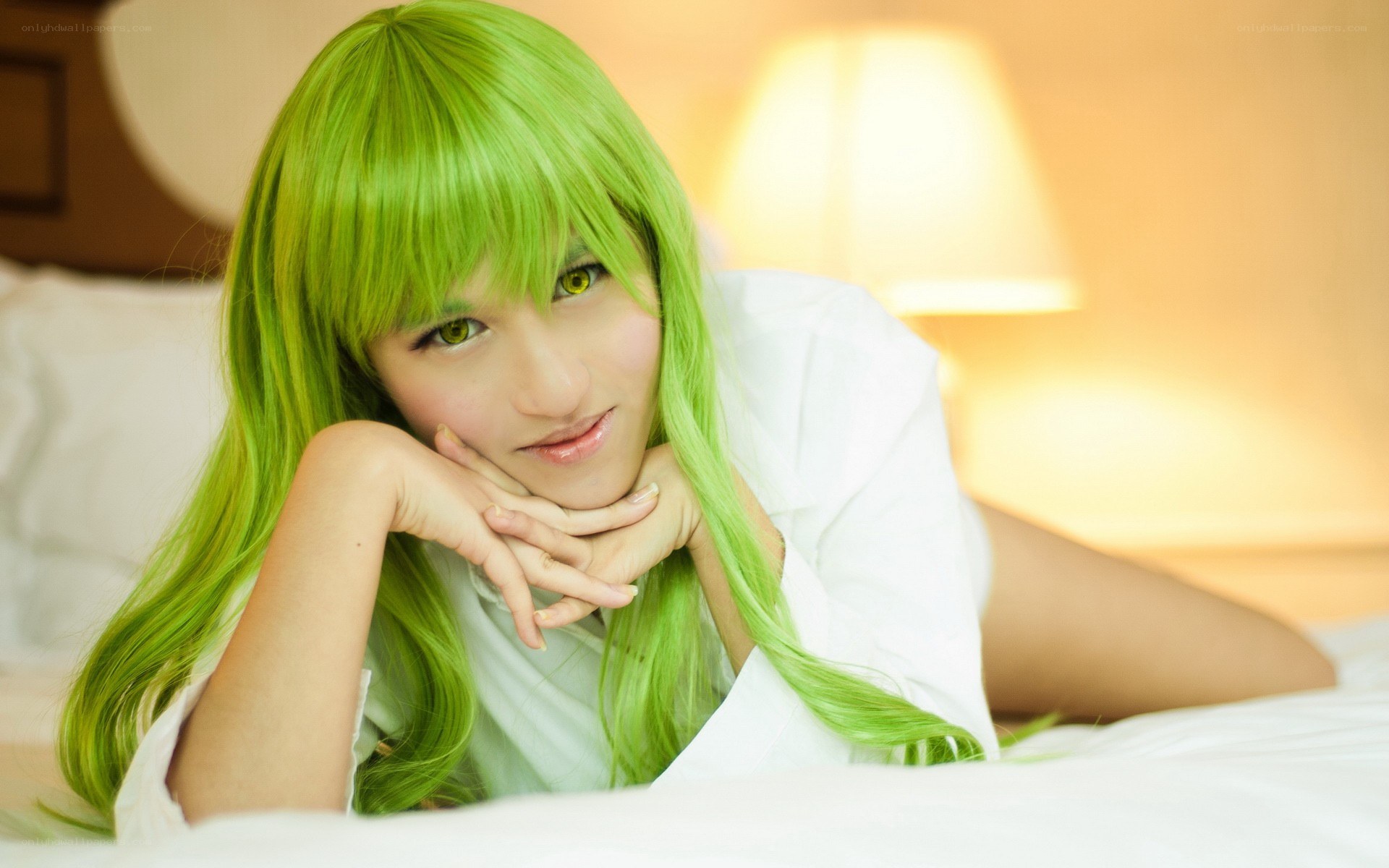 green-haired cosplayer on bed