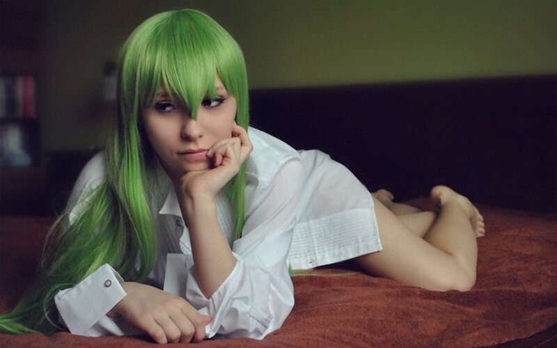 green-haired cosplayer on bed