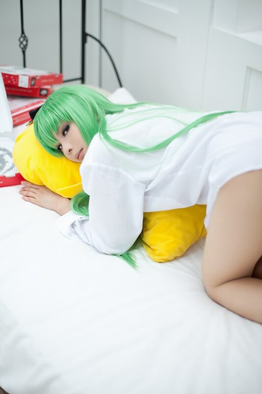 green-haired cosplayer on bed