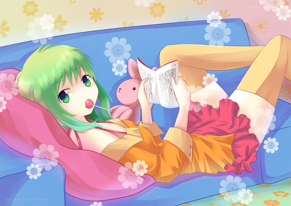Green-haired girl reading on a couch
