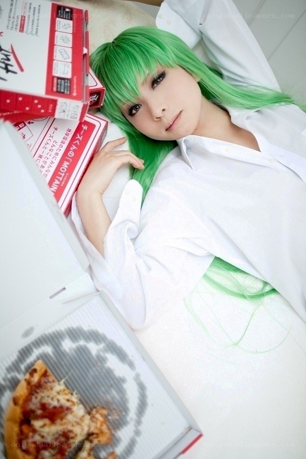 green-haired person with pizza boxes
