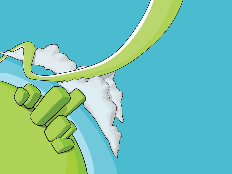 green hand holding white object
