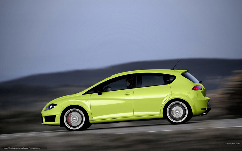 green hatchback car in motion