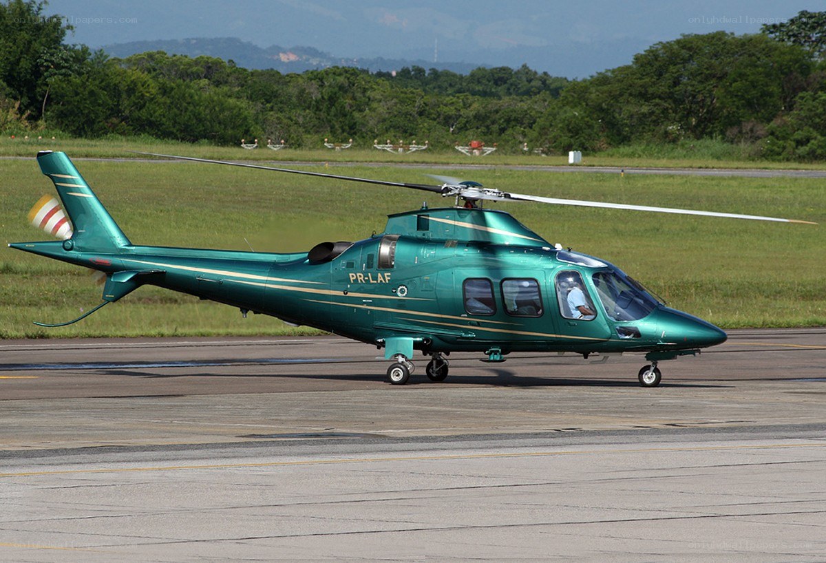 Green helicopter on runway