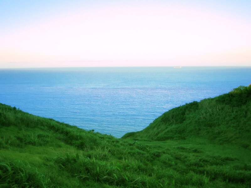 Green Hill Overlooking Ocean — Blue, Serene, Sunset