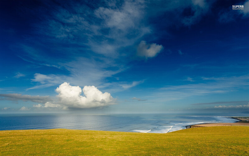Green Hill Overlooking Ocean — Blue
