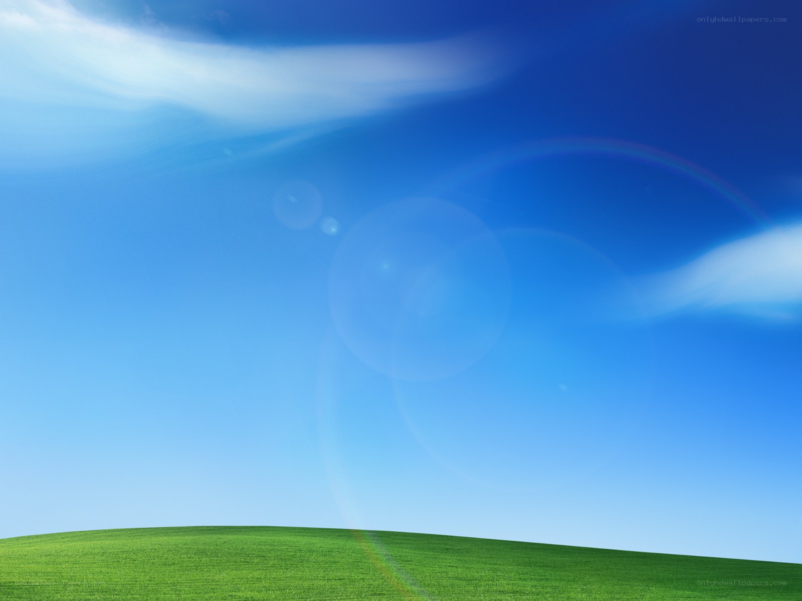 green hill under blue sky