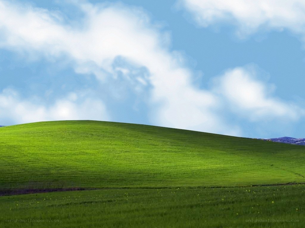 green hill under blue sky
