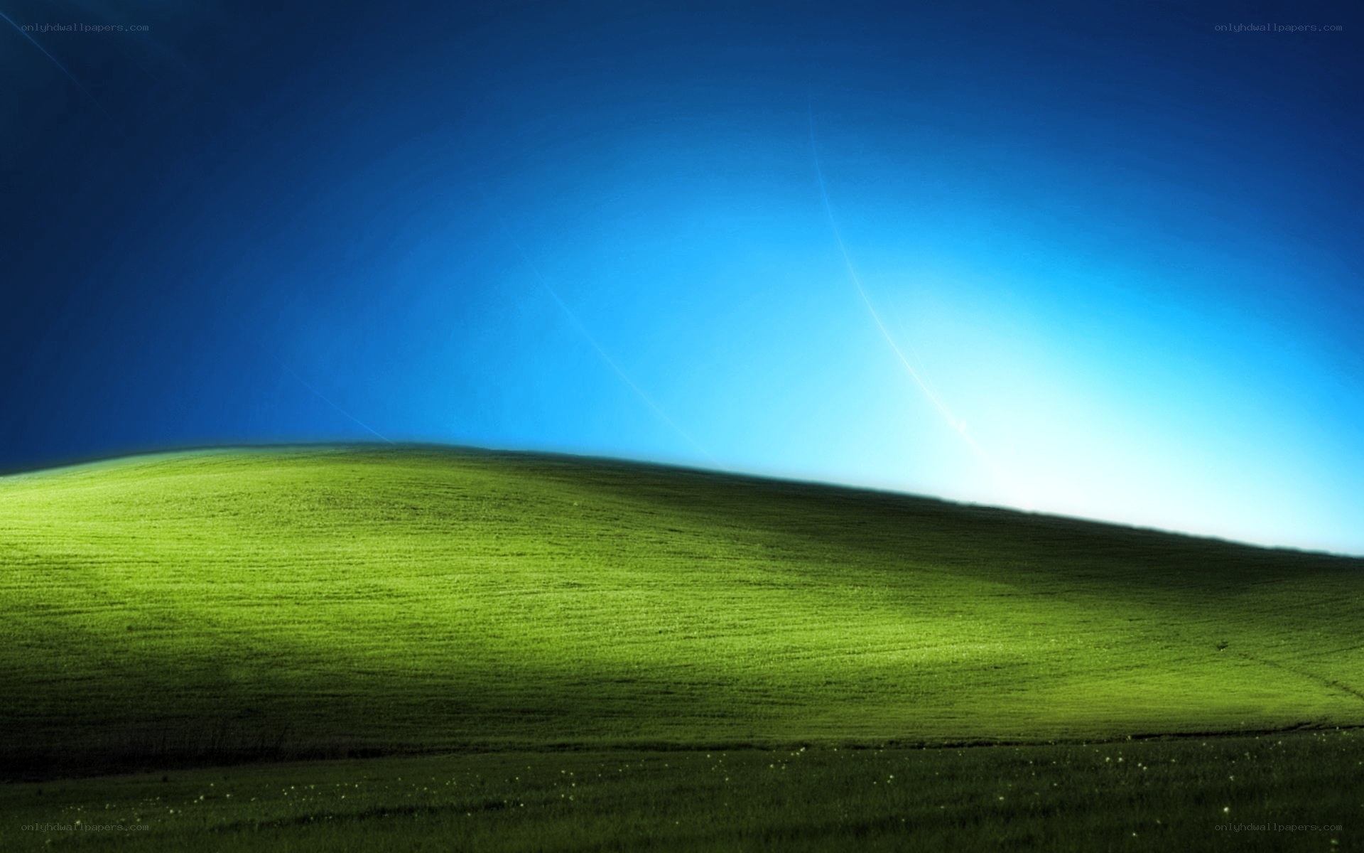 green hill under blue sky