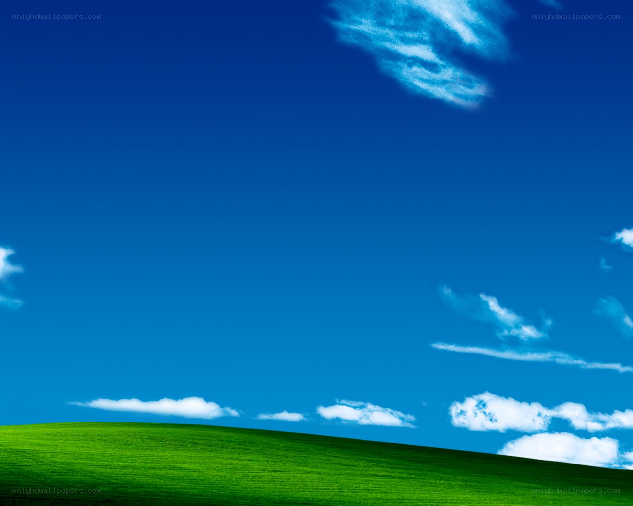green hill under blue sky