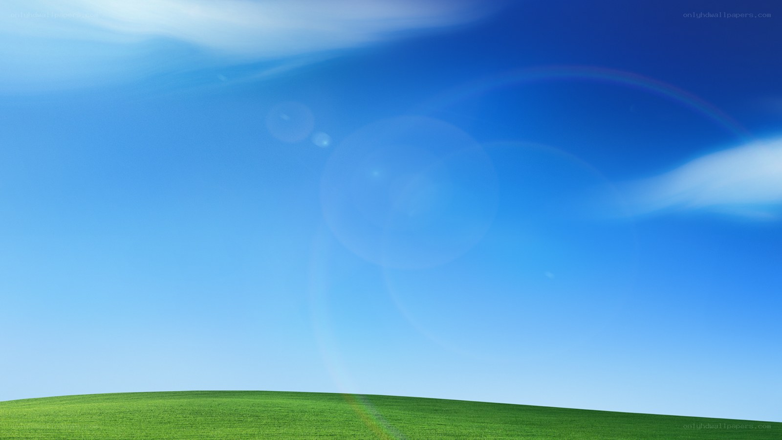green hill under blue sky