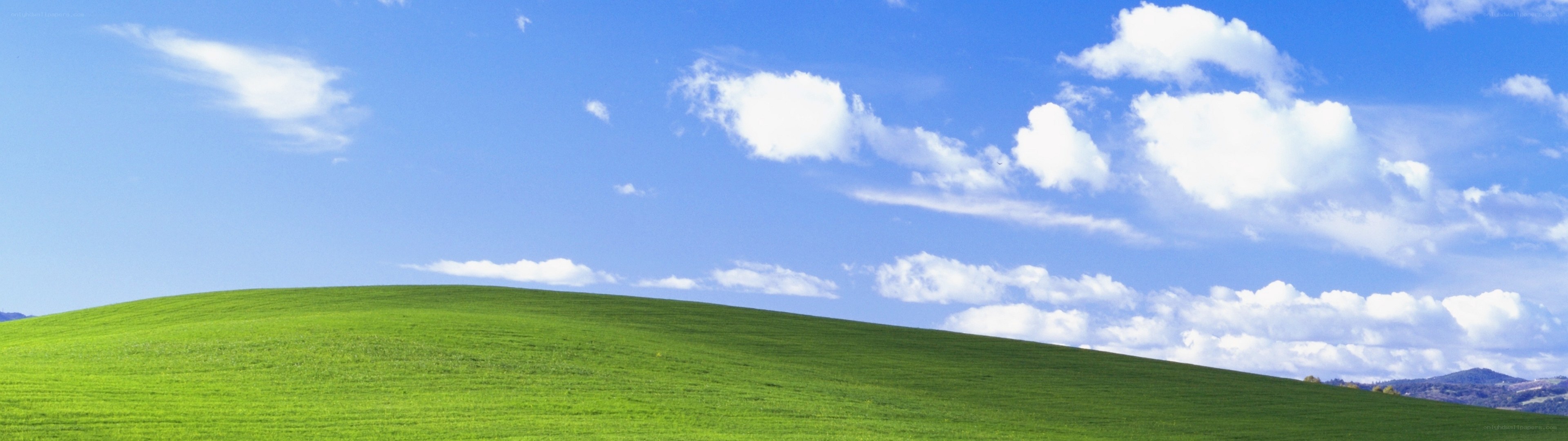green hill under blue sky
