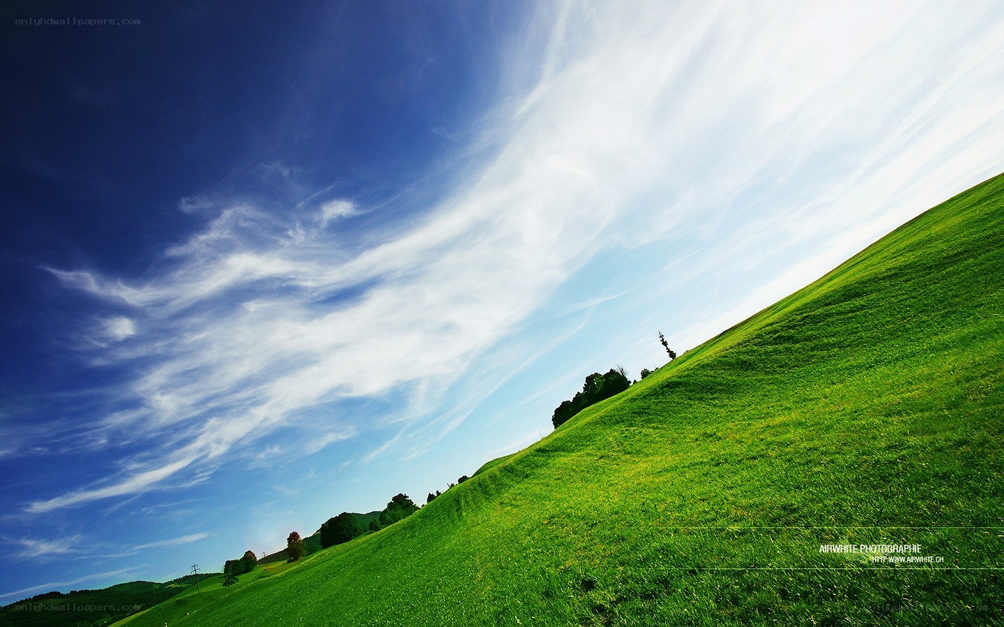 Green Hill Under Blue Sky