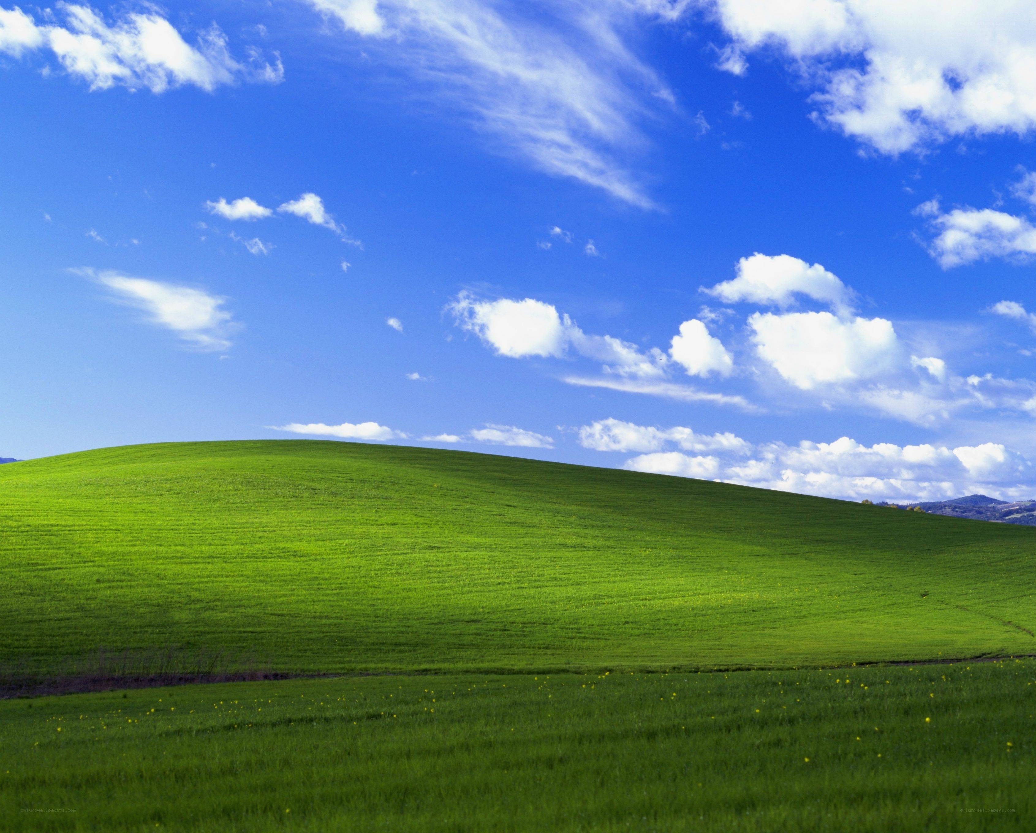 Green hill under blue sky
